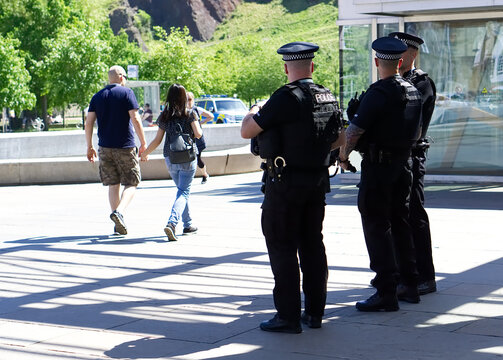 Police officer on duty on a city centre street during special event. 