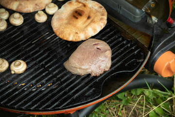 Frying meat on street Cooking food on vacation, Street kitchen. Picnic details.