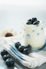 yogurt with fresh blueberry on a wooden background. healthy cereal morning breakfast.