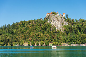 Lake Bled with the medieval Bled Castle (Blejski grad), XI century, on a sunny summer day. Bled town, Gorenjska, Triglav National Park, Slovenia, central Europe.