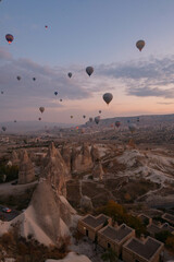 Views of a city with caves and hot air balloons