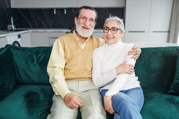 Happy elderly married couple have fun video calls with children