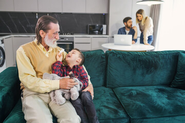 loving grandfather embraces his little grandson