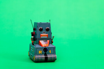 Retro robot toy on green background