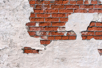 Old red brick wall. White plaster peeling. Background image with copy space