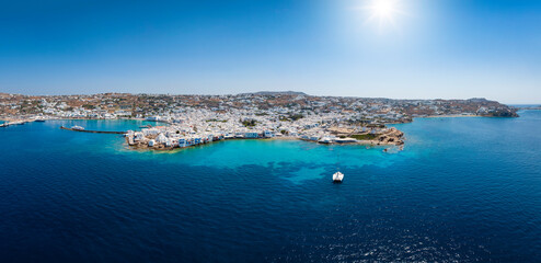 Wide, aerial panorama of the town amd harbour of Mykonos island, Cyclades, Greece, during summer time - obrazy, fototapety, plakaty