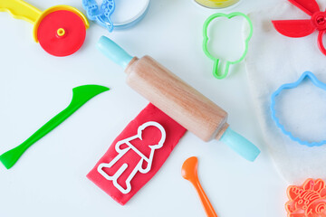 Homemade modeling clay tools kit. Colorful plasticine with roller and human shape. Home education game with play dough . High quality photo