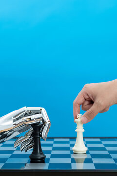 Human playing chess with robot