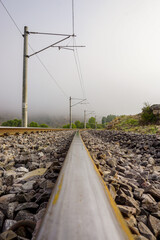 Fototapeta na wymiar Railroad in the nature on a foggy morning