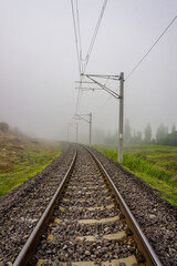 Railroad in the nature on a foggy morning