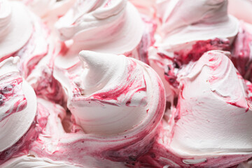 Frozen Cherry flavour gelato - full frame detail. Close up of a white surface texture of Ice cream covered with red stripes.