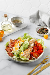 Cobb salad with bacon, avocado, tomato, grilled chicken, eggs isolated on  white background....