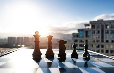Chess pieces on city background