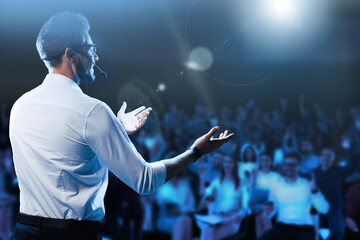 Fototapeta Motivational speaker with headset performing on stage obraz