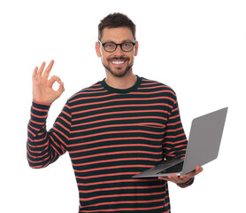 Smiling man with laptop showing okay gesture on white background