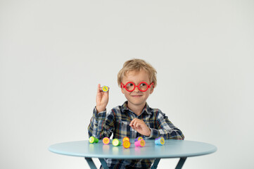 Boy sitting at a table, showing lotto number, school grade