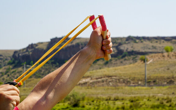 Man using spear thrower throwing rock nature amusement