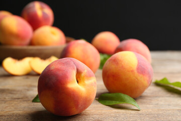Naklejka na ściany i meble Fresh sweet peaches on wooden table, closeup