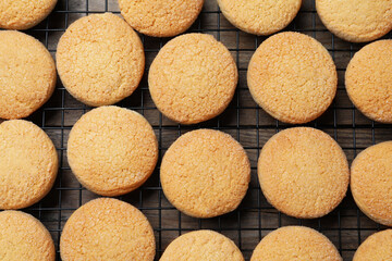 Many tasty sugar cookies on wooden table, top view