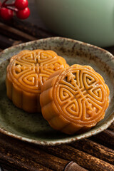 Delicious Cantonese moon cake for Mid-Autumn Festival food mooncake on wooden table background.