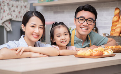 Young Asian family in the kitchen