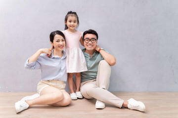 Young Asian family sitting on the floor