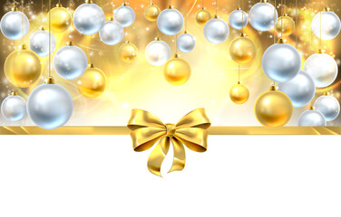 Gold Christmas baubles and ribbon bow decoration abstract background. White at the bottom for easy use as border design or header.