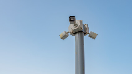 security camera in front of sky background, close up