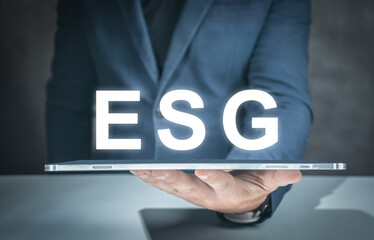 ESG environmental social governance business strategy investing concept. businessman hand with tablet and ESG text