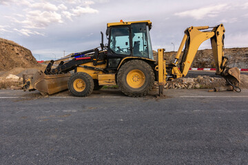 A backhoe at a road construction site