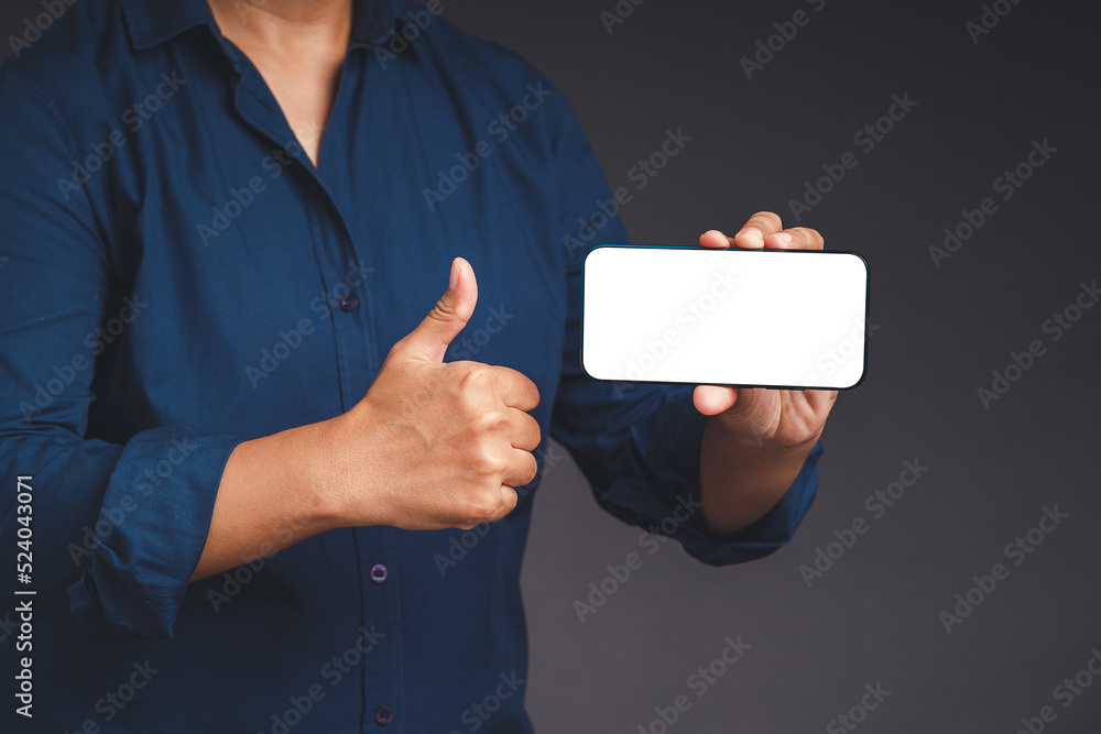 Poster hand holding a horizontal mobile phone with a blank white screen and showing thumbs up while standin