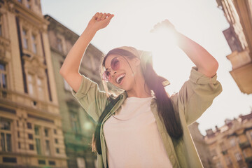 Portrait of pretty cheerful overjoyed person enjoy dancing warm sunny weather city center outside