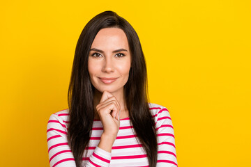 Close up photo of stunning young woman touch chin create start up strategy wear stylish striped clothes isolated on yellow color background