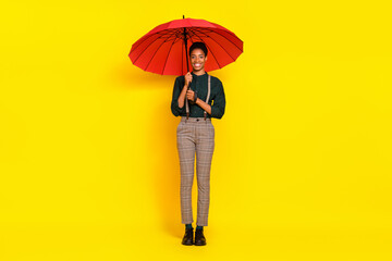 Full length body size view of attractive cheery woman holding parasol walk isolated over vibrant...