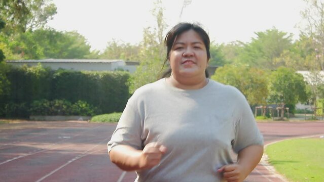 Fat Asian woman wearing red boxing gloves Exercise to lose weight in the morning. Sports concepts, health care. weight loss