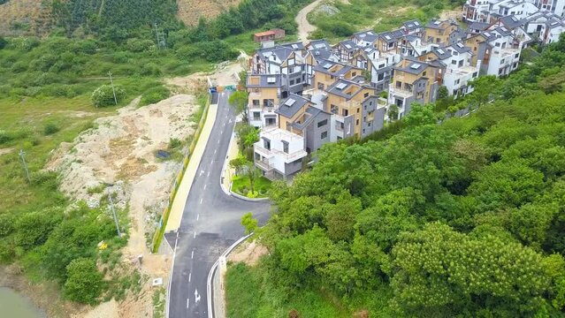 Aerial photography of a group of Chinese-style villas in the outdoor forest and mountains