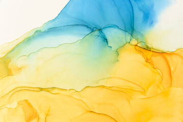 Abstract alcohol ink fluid art background. Blue and yellow color