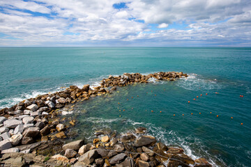 View on water of Ligurian Sea and rocks, picturesque landscape, Riomaggiore, Cinque Terre, Italy