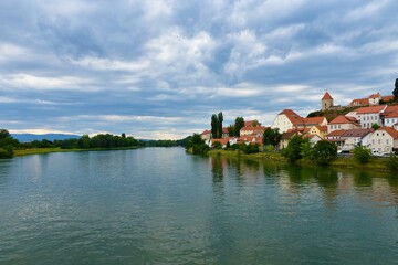 View of Drava river and Ptuj town on the shore in Stajerska, Slovenia with clouds in the sky