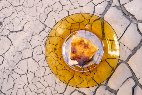 Hunger Due To Famine And Drought. The Last Piece Of Dry Bread Left On The Plate.