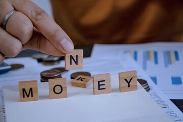 hand put word N for meaning of money. concept of money debt management.