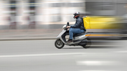 Abstract blur image of scooter courier