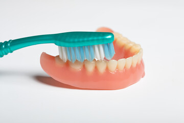 Denture and toothbrush - dental cleaning instruction