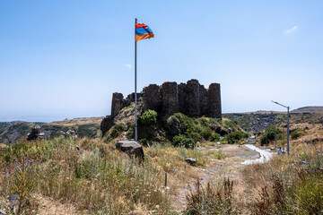 ancient stone dilapidated fortress in a picturesque place in the mountains of Armenia