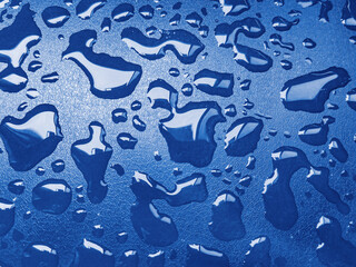 Water drops on blue leather on rainny day. Humid weather.

