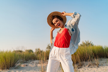 stylish attractive woman on beach in summer style fashion trend outfit happy having fun
