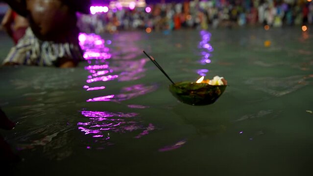 Shedding lamp and flowers in the ganges
