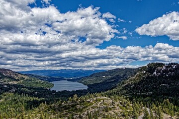 Lake Tahoe in the background of the rocky mountains covered in forests