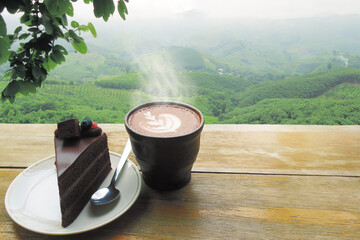 Chocolate hot cup and cake on wooden bar with natural high agriculture mountain view