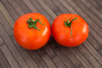 ripe appetizing rispentomatoes tomatoes on wooden table